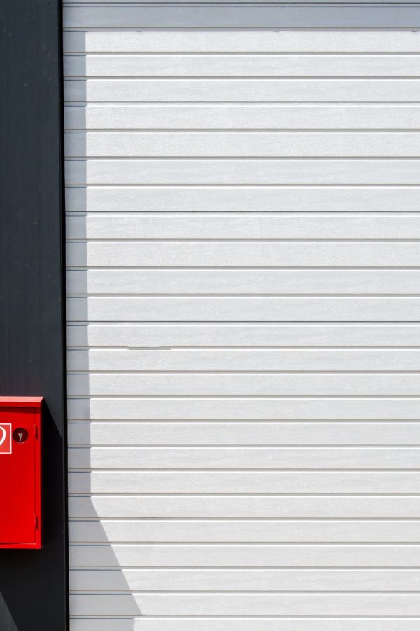 red-fire-box-hung-black-white-surface-with-lines-min